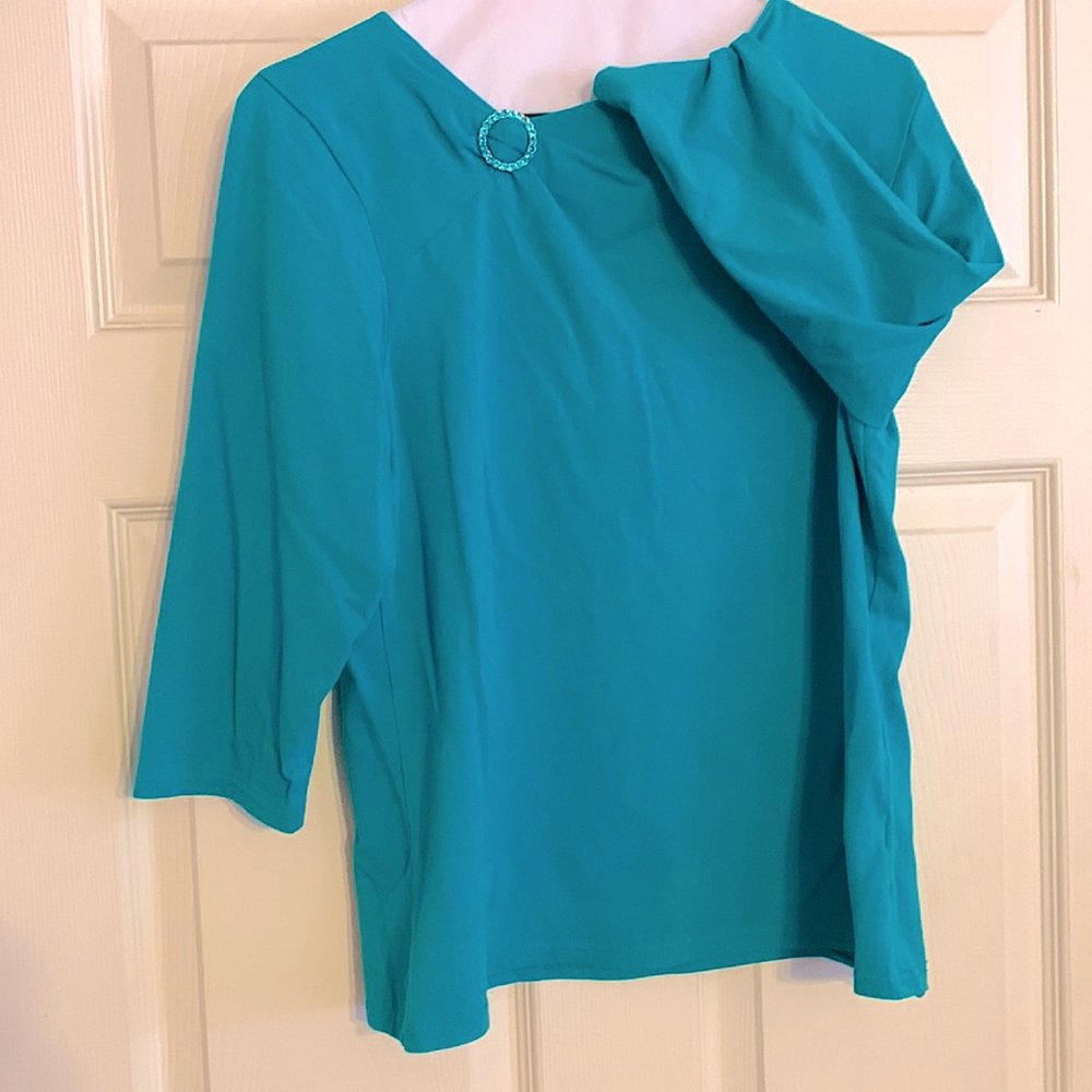 Teal bejeweled blouse. Good condition. Quarter length sleeves.